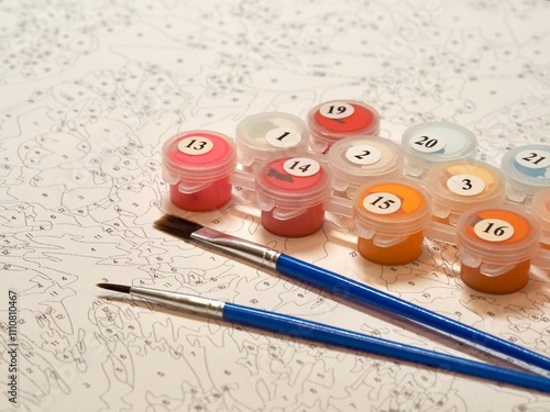 An intricate paint by numbers canvas accompanied by labeled paint pots and brushes, designed to guide artists in creating a detailed and satisfying masterpiece.
