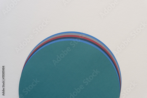 detail of staggered pile of paper circles on blank paper photo