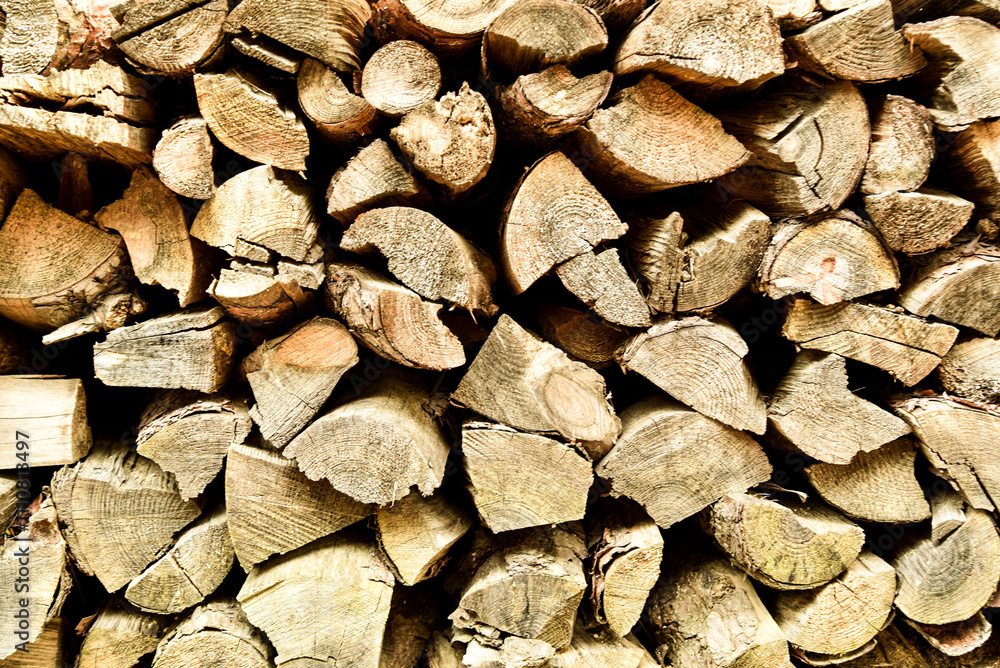 A pile of wood logs stacked on top of each other A pile of wood logs stacked on top of each other