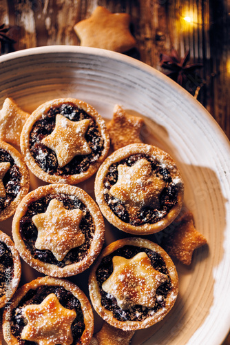 Close-up view of the Christmas cookies sprinkled with icing sugar. Traditional british Christmas dessert, mince piest photo