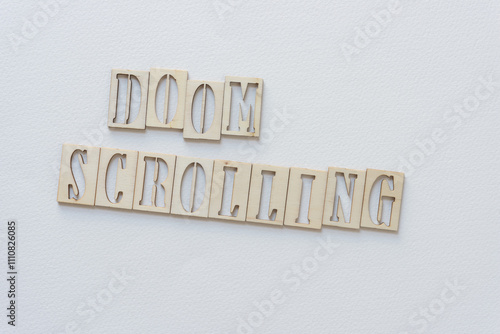 laser-cut wooden stencil font letters sign: doom scrolling