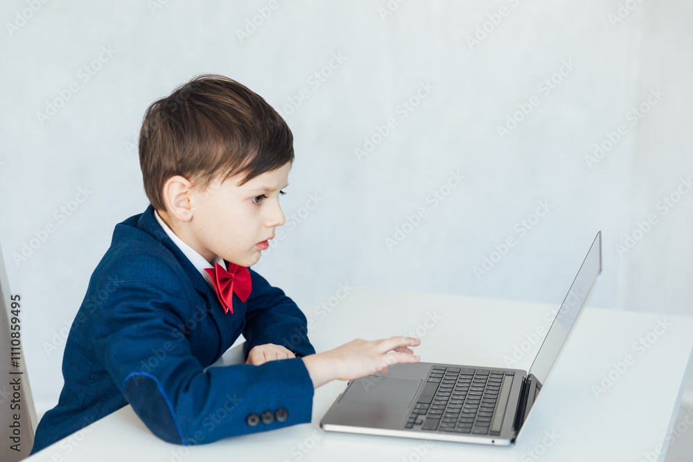 Boy In Business Suit Studying Playing On Laptop Online Boy In Business Suit Studying Playing On Laptop Online