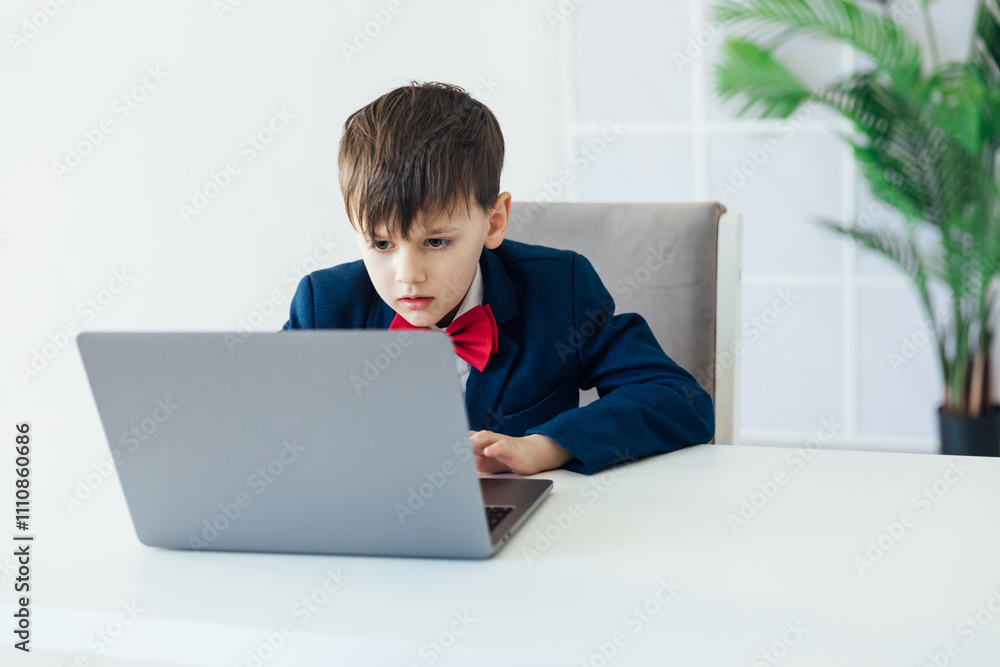 Boy In Business Suit Studying Playing On Laptop Online Boy In Business Suit Studying Playing On Laptop Online