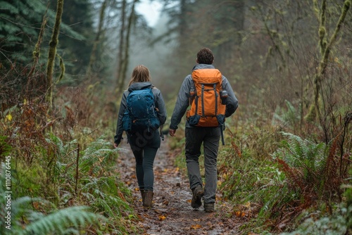 Hikers walking on muddy trail in lush forest