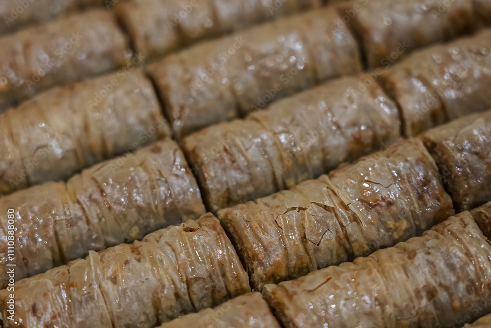 Baclava layered pastry dessert made of filo pastry, filled with chopped nuts, and sweetened with syrup or honey. Baclava or pakhlava the sweet pastries of Ottoman, Arabian, Persian and Greek cuisine Baclava layered pastry dessert made of filo pastry, filled with chopped nuts, and sweetened with syrup or honey. Baclava or pakhlava the sweet pastries of Ottoman, Arabian, Persian and Greek cuisine