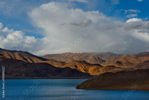 Tajikistan. A picturesque sunset in the valley of the mountainous desert lake Bulunkul on the northeastern section of the Pamir tract. photo