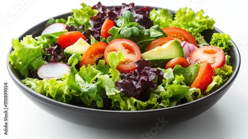 A fresh salad with lettuce, tomato, avocado, and radish in a black bowl.