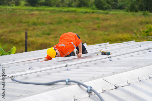 Men technicians mounting photovoltaic solar moduls on roof of house. photo