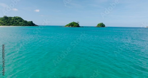 Flying over clear turquoise water to Bolog Islands in El Nido, Palawan. Philippines. photo