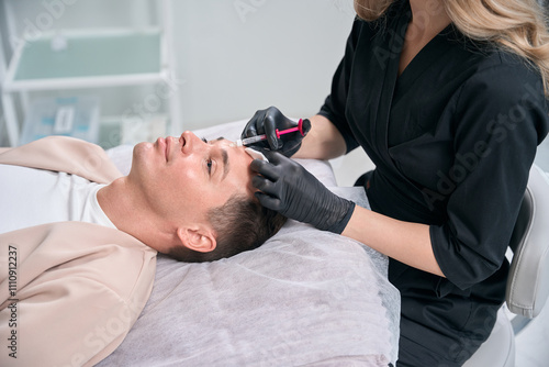 Beautician expert making dermal fillers injections