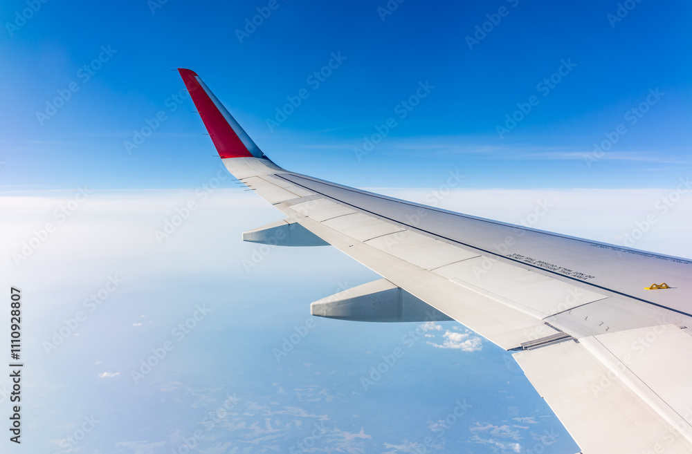 View from the airplane window at a beautiful cloudy sky and the airplane wing View from the airplane window at a beautiful cloudy sky and the airplane wing