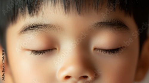 Close-up of a child's serene face with closed eyes reflecting calmness and innocence during a peaceful moment at home in the afternoon