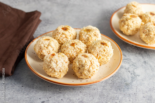 Moa is a traditional Bengali sweet made of puffed rice, jaggery, and coconut, often shaped into small, round balls. photo