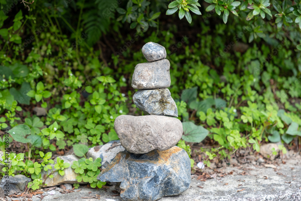 Zen stones, balance tower, green plants background, japanese garden Zen stones, balance tower, green plants background, japanese garden