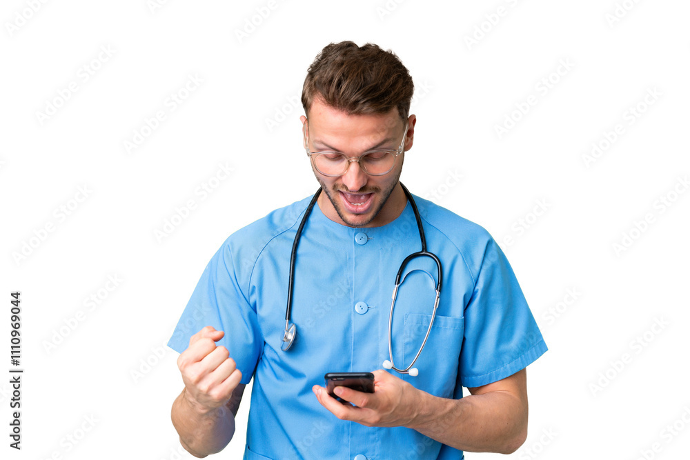 Young nurse man over isolated chroma key background surprised and sending a message Young nurse man over isolated chroma key background surprised and sending a message