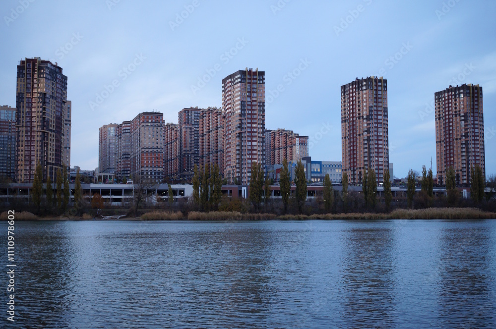 View of residential buildings and the river bank. View of residential buildings and the river bank.
