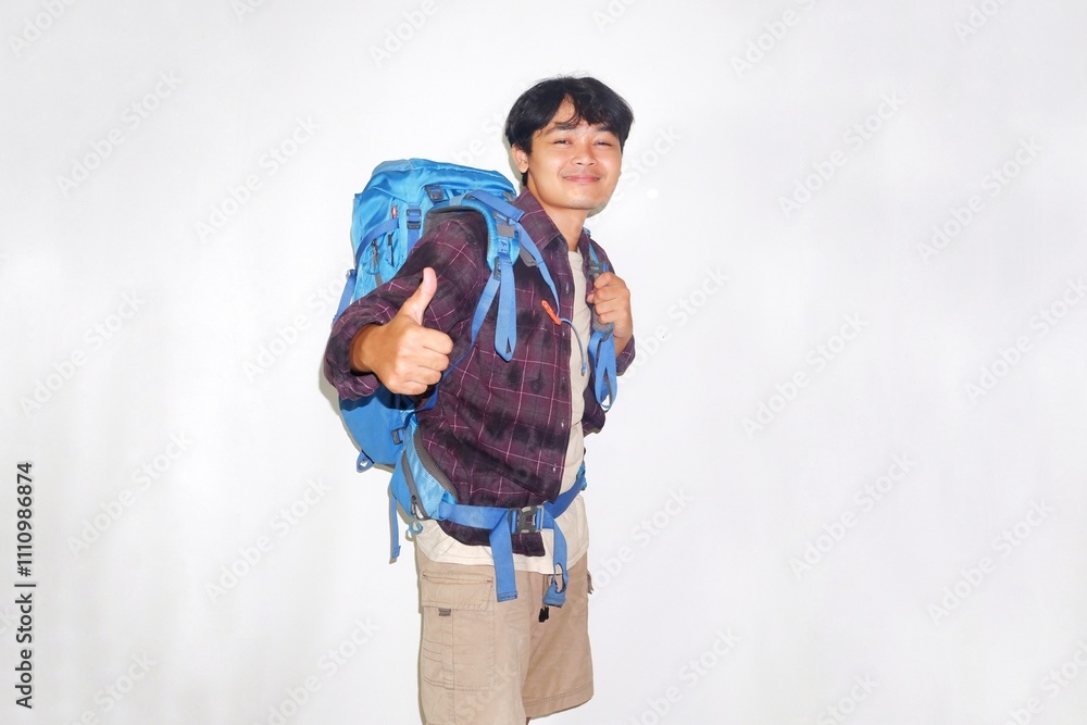 Handsome Asian man wearing blue gravel bag, hiking or vacationing very helpful on isolated white background Handsome Asian man wearing blue gravel bag, hiking or vacationing very helpful on isolated white background