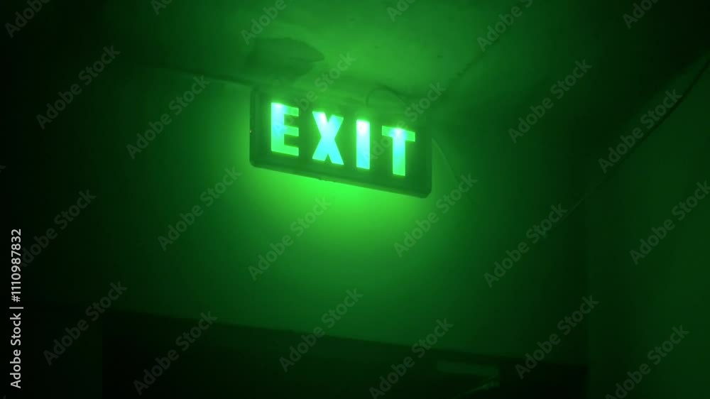 Horizontal video. Fire exit sign in house. Green light. Glowing inscription. Concept of emergency, problem solving, trip, fear, horror, gestalt psychology. Led lamp. Copy space. Hotel. Entrance door Horizontal video. Fire exit sign in house. Green light. Glowing inscription. Concept of emergency, problem solving, trip, fear, horror, gestalt psychology. Led lamp. Copy space. Hotel. Entrance door