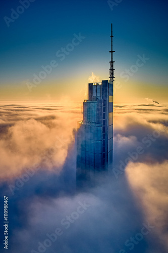 Beautiful panoramic fabulous, mesmerizing, unreal, aerial drone view of skyscrapers sticking out of low fog at sunrise, Warsaw, Poland, EU. VARSO - the tallest skyscraper in EU.