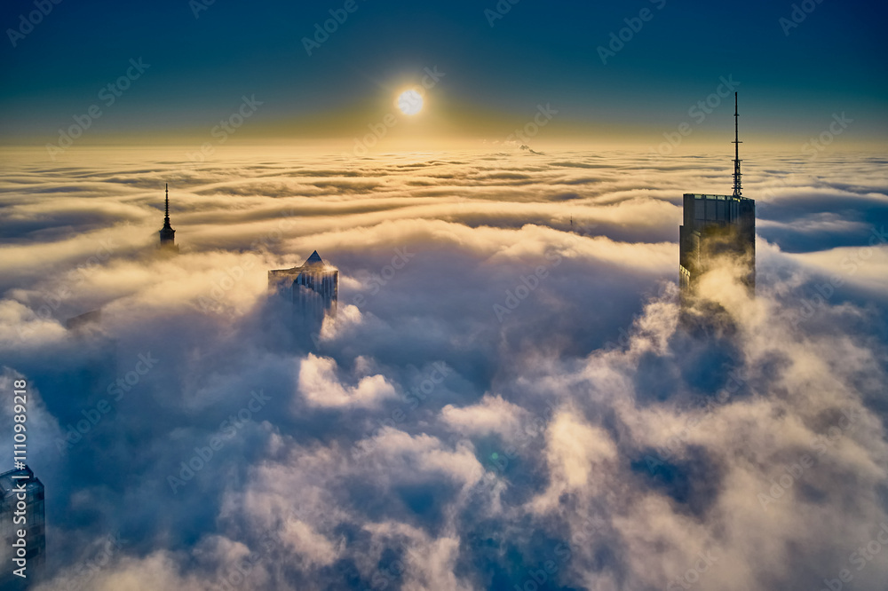 Beautiful panoramic fabulous, mesmerizing, unreal, aerial drone view of skyscrapers sticking out of low fog at sunrise, Warsaw, Poland, EU. VARSO - the tallest skyscraper in EU.