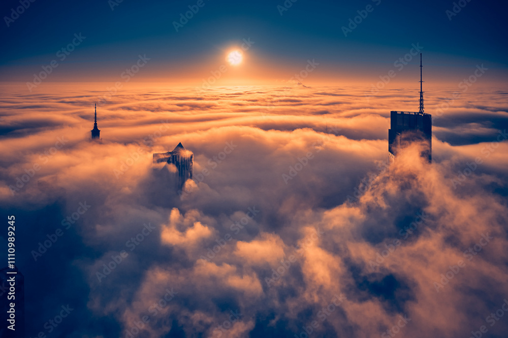 Beautiful panoramic fabulous, mesmerizing, unreal, aerial drone view of skyscrapers sticking out of low fog at sunrise, Warsaw, Poland, EU. VARSO - the tallest skyscraper in EU.
