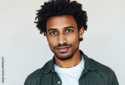 Studio portrait of a man with a friendly expression, casual and minimal outfit