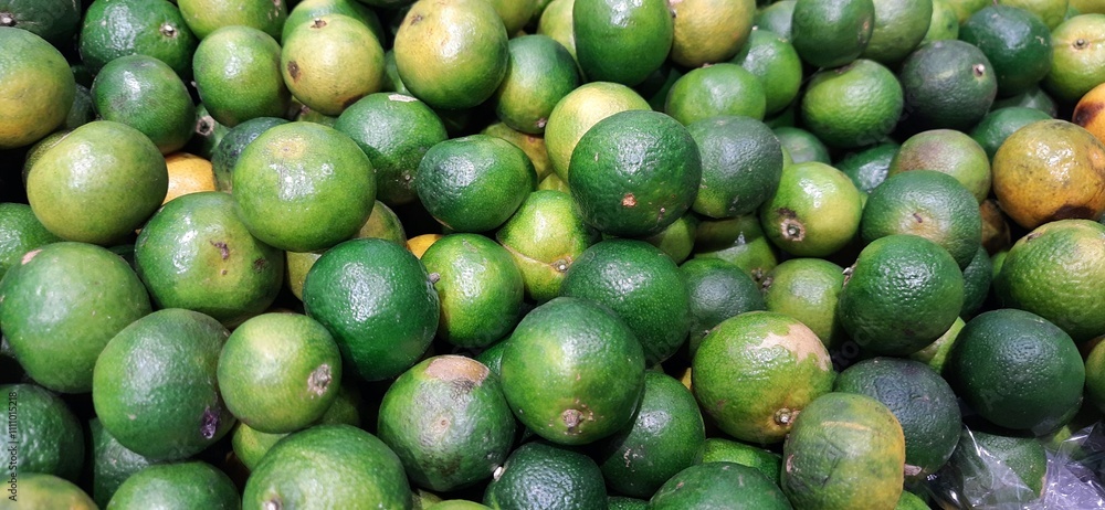 Pile of lime or lemon fruits background ready to sell on the supermarket Pile of lime or lemon fruits background ready to sell on the supermarket