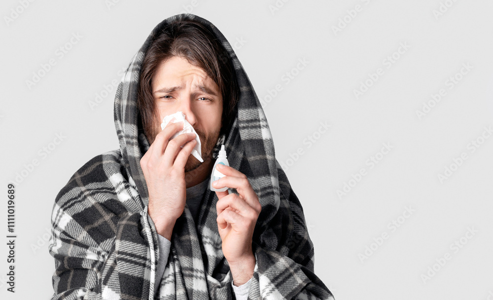 Cold symptoms and nose treatment concept. Man drips nose with spray Cold symptoms and nose treatment concept. Man drips nose with spray