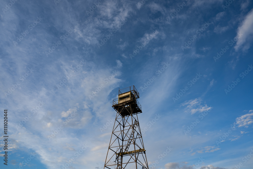 An old Soviet border tower in Neeme against a blue cloudy sky. An old Soviet border tower in Neeme against a blue cloudy sky.