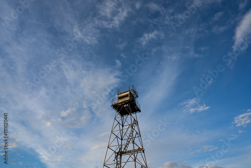 An old Soviet border tower in Neeme against a blue cloudy sky. photo