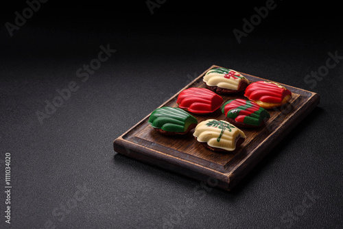 Sweet madeleine sponge cookies covered with colored chocolate photo