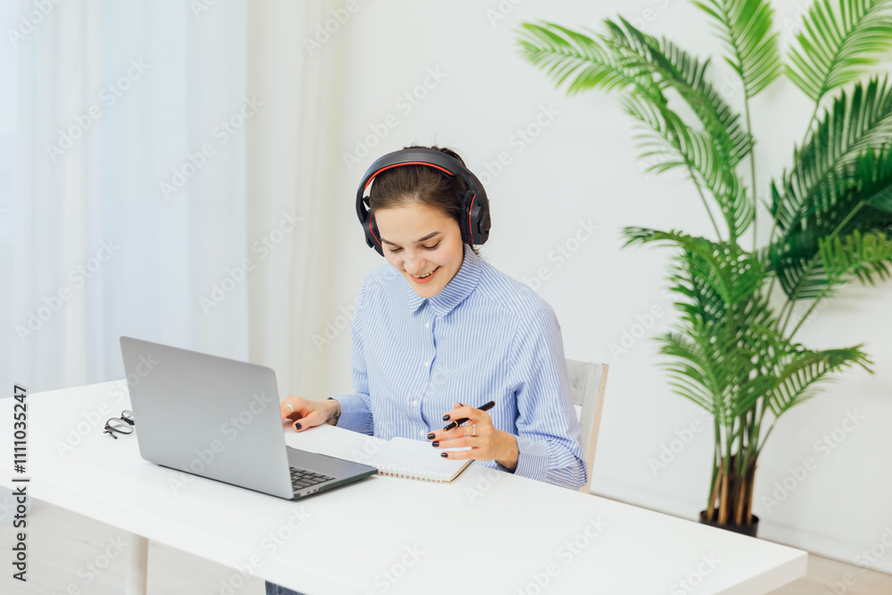 Business woman in headphones learning online laptop in office Business woman in headphones learning online laptop in office