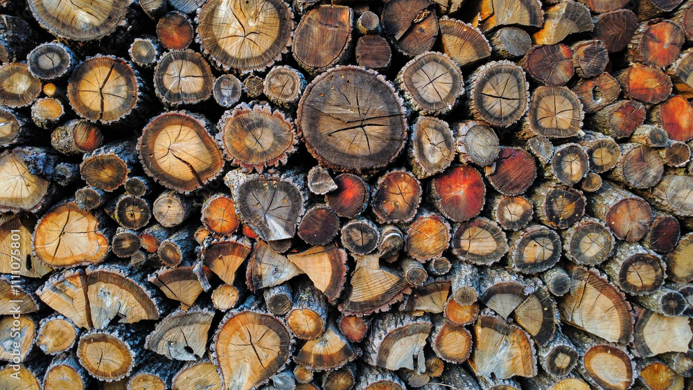 Stacked firewood creating intricate pattern of wood grain and texture Stacked firewood creating intricate pattern of wood grain and texture