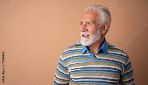 Older man with a joyful expression poses against a pastel background, showcasing excitement and warmth in a vibrant, colorful sweater