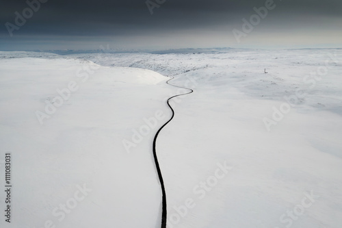 Winding Road Through Snowy Landscape photo