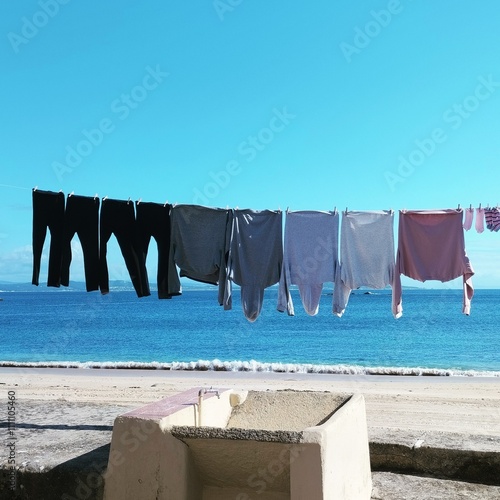 Clothes weigh on the rope by the ocean photo