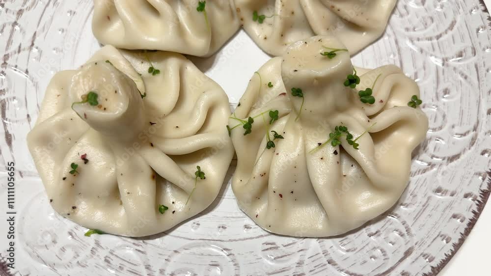Boiled khinkali on white-brown dish on white table Boiled khinkali on white-brown dish on white table