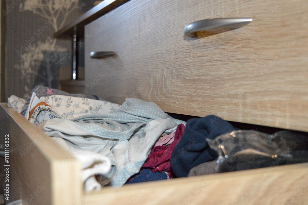 open drawer filled with clothes towels storage systems wardrobe organization or closet solutions laundry detergents fabric softeners сleaning bedroom furniture dressers drawer decluttering minimalism open drawer filled with clothes towels storage systems wardrobe organization or closet solutions laundry detergents fabric softeners сleaning bedroom furniture dressers drawer decluttering minimalism