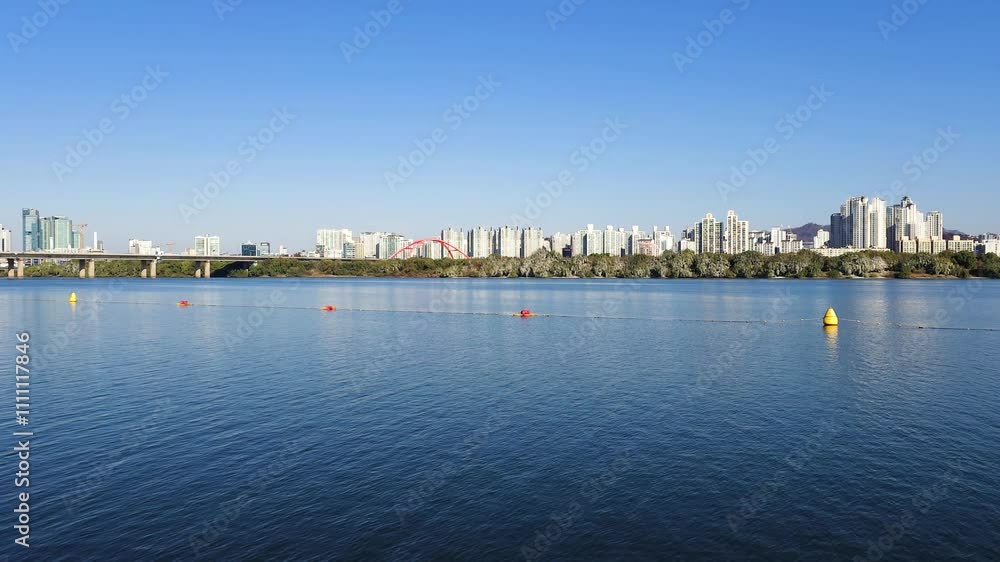 panoramic view of the Hangang river, Yeouido Hangang River Park, in Seoul, Korea, with a broad bridge, and a cityscape in the backdrop
panoramic view of the Hangang river, Yeouido Hangang River Park, in Seoul, Korea, with a broad bridge, and a cityscape in the backdrop