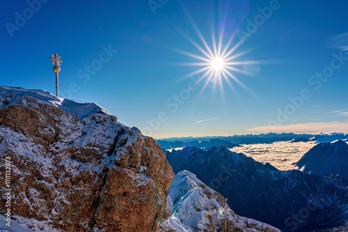 View of the summit cross on the Zugspitze, the highest mountain peak in Germany. photo