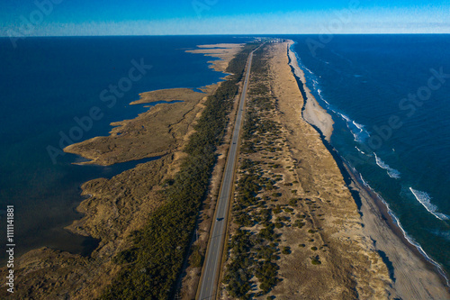 Drone aerial view of Outer Banks Highway 12 with Atlantic Ocean and Sound on both sides, Cape Hatteras National Seashore NP