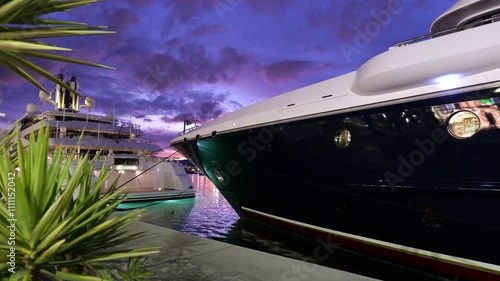 multiple superyachts docked port malaga during sunset luxurious lifestyle their owners panning shot luxury scenic experience coastal architecture beauty aesthetics illumination visuals  photo