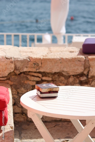 Books on a tabke by the sea photo