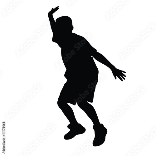 A boy is playing basketball. He is wearing a black shirt and shorts. He is jumping up in the air