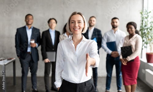 Cheerful Businesswoman Stretching Hand For Handshake Greeting To Camera Making Career Offer Standing In Modern Office. Recruitment And Employment, Human Resources, Join Our Team Concept