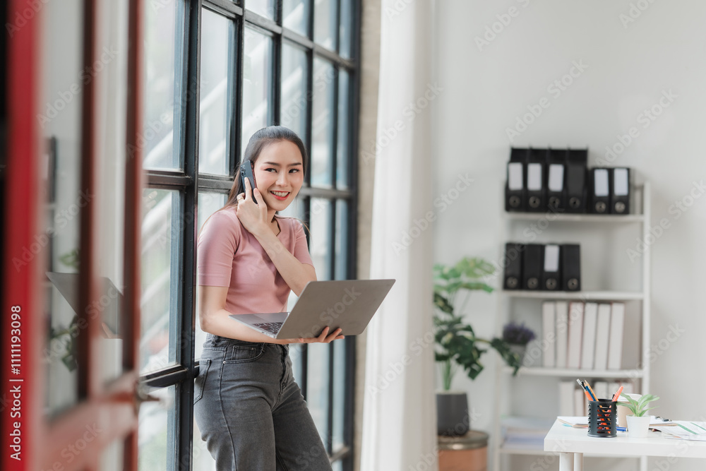 Smiling Businesswoman with Laptop by Window Smiling Businesswoman with Laptop by Window