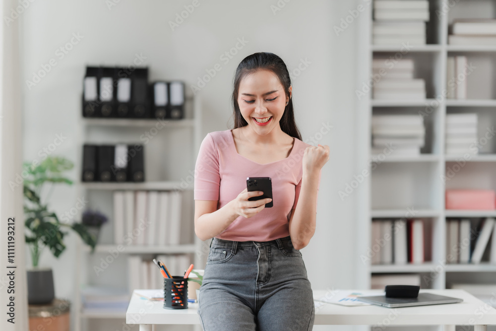 Joyful Businesswoman Celebrating Success on Smartphone Joyful Businesswoman Celebrating Success on Smartphone