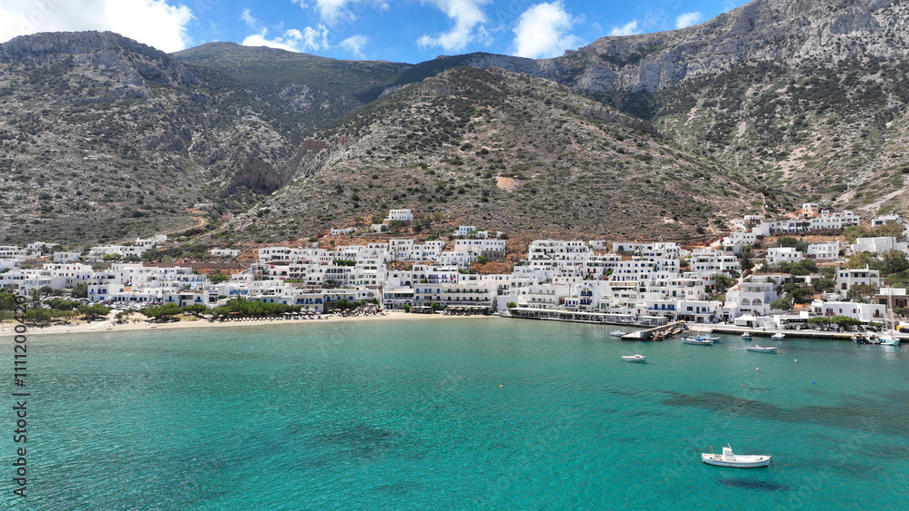 Obraz premium Aerial drone photo of famous port and small picturesque seaside village of Kamares, Sifnos island, Cyclades, Greece