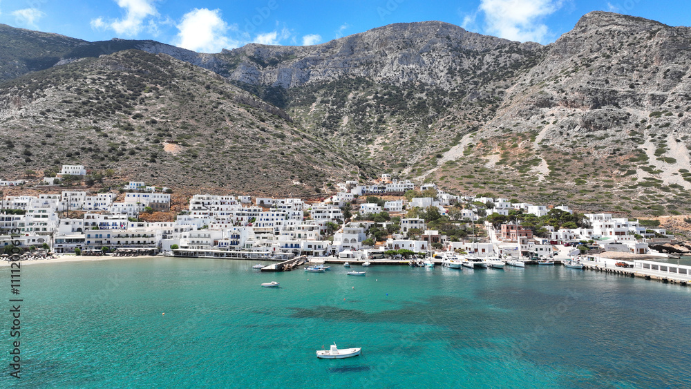 Obraz premium Aerial drone photo of famous port and small picturesque seaside village of Kamares, Sifnos island, Cyclades, Greece