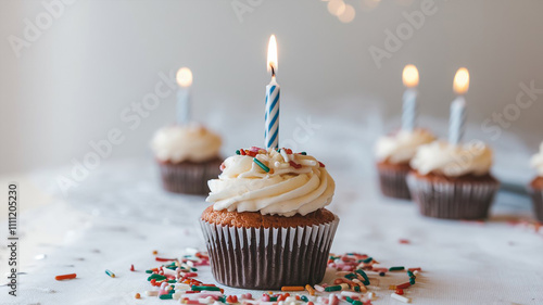 a delicious birthday cupcake with frosting, colorful sprinkles and a candle on top, on a table